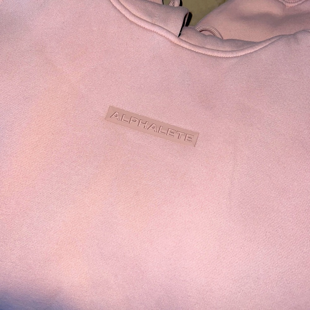 This is a men’s light pink alphalete sweatshirt.